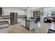 Modern kitchen with white cabinets, granite island, and stainless steel appliances at 19304 Bluff Dr, Venice, FL 34292