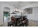 Open dining area with modern light fixture and view into kitchen and living room at 19304 Bluff Dr, Venice, FL 34292