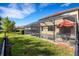 Large backyard with a screened-in pool and lush lawn at 19304 Bluff Dr, Venice, FL 34292