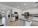 Modern kitchen with white cabinets, granite island, and stainless steel appliances at 19304 Bluff Dr, Venice, FL 34292