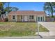 Quaint yellow house with a double-door garage and mailbox at 2616 Osage Rd, Venice, FL 34293