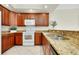 Kitchen with granite countertops and wood cabinets at 3314 Wood Thrush Dr # 124, Punta Gorda, FL 33950