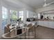 Virtually staged eat-in kitchen with white cabinets and a breakfast nook at 1622 Monarch Dr # 1622, Venice, FL 34293