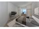 Virtually staged bedroom with a bed, desk, and TV at 1622 Monarch Dr # 1622, Venice, FL 34293