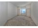 Well-lit bedroom with neutral carpeting and double doors at 1622 Monarch Dr # 1622, Venice, FL 34293