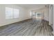 Living room with gray wood-look flooring and access to other rooms at 1622 Monarch Dr # 1622, Venice, FL 34293