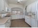 Kitchen with white cabinets, beige countertops, and tile floors at 1622 Monarch Dr # 1622, Venice, FL 34293