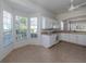 Bright kitchen with white cabinets, and tile flooring at 1622 Monarch Dr # 1622, Venice, FL 34293