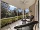 Virtually staged screened lanai with outdoor seating and lush landscaping views at 1622 Monarch Dr # 1622, Venice, FL 34293