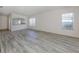 Spacious living room with wood-look floors and views into the kitchen at 1622 Monarch Dr # 1622, Venice, FL 34293