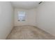Bright bedroom with neutral carpeting and a window at 1622 Monarch Dr # 1622, Venice, FL 34293