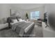 Virtually staged bedroom with grey bedding and a large window at 1622 Monarch Dr # 1622, Venice, FL 34293
