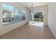 Bright sunroom with tile floors and access to the screened lanai at 1622 Monarch Dr # 1622, Venice, FL 34293