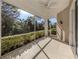 Bright screened porch with lush green views and ceiling fan at 1622 Monarch Dr # 1622, Venice, FL 34293