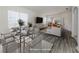 Virtually staged dining room with a glass table and gray chairs at 1622 Monarch Dr # 1622, Venice, FL 34293