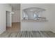 Open kitchen with white cabinets and a breakfast bar at 1622 Monarch Dr # 1622, Venice, FL 34293