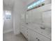 Bathroom with double vanity, a large mirror, and a shower at 1622 Monarch Dr # 1622, Venice, FL 34293