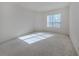 Bright bedroom with neutral carpeting and a large window at 1622 Monarch Dr # 1622, Venice, FL 34293
