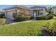 Tan house exterior with a two-car garage and manicured lawn at 1622 Monarch Dr # 1622, Venice, FL 34293