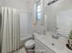 Bathroom with shower/tub combo, vanity, and mirror; virtually staged at 1622 Monarch Dr # 1622, Venice, FL 34293