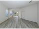 Open living room with gray wood-look flooring and lots of natural light at 1622 Monarch Dr # 1622, Venice, FL 34293