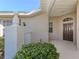 Front entrance with a brown door and pineapple-shaped column at 1622 Monarch Dr # 1622, Venice, FL 34293