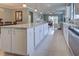 Large kitchen island with granite countertop and white cabinets at 13872 Rinuccio St, Venice, FL 34293