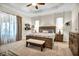 Main bedroom with king-size bed, ample natural light, and ensuite bath at 25143 Spartina Dr, Venice, FL 34293