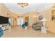Bright living room with tiled floors, seating, and a view of the entryway at 16093 Hillsborough Blvd, Port Charlotte, FL 33954