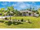 One-story home with palm trees and lush lawn at 16093 Hillsborough Blvd, Port Charlotte, FL 33954