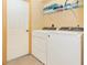 Laundry room with washer, dryer, and shelving at 16093 Hillsborough Blvd, Port Charlotte, FL 33954