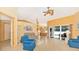 Living room with vaulted ceiling, tiled floors, and access to the pool area at 16093 Hillsborough Blvd, Port Charlotte, FL 33954
