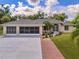 Single-Gathering home with a three-car garage and nicely landscaped front yard at 16093 Hillsborough Blvd, Port Charlotte, FL 33954