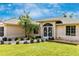 House exterior featuring a landscaped yard and an inviting entrance at 16093 Hillsborough Blvd, Port Charlotte, FL 33954