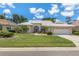 Attractive single-story home with tile roof, landscaping, and a two-car garage at 1136 Highland Greens Dr, Venice, FL 34285