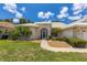 House exterior with walkway, landscaping, and a screened entryway at 1136 Highland Greens Dr, Venice, FL 34285