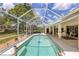 Inviting screened pool with lush landscaping views at 1136 Highland Greens Dr, Venice, FL 34285