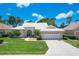 Single-story home with tile roof, lush lawn, and attractive curb appeal at 1136 Highland Greens Dr, Venice, FL 34285