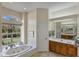 Spa-like bathroom with a large soaking tub and garden views at 1136 Highland Greens Dr, Venice, FL 34285