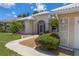 Partial view of house exterior, highlighting landscaping and walkway at 1136 Highland Greens Dr, Venice, FL 34285