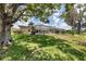 Large backyard with pool and spacious patio area, shaded by large trees at 1136 Highland Greens Dr, Venice, FL 34285