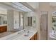 Elegant bathroom with double sinks, a soaking tub, and a shower at 1136 Highland Greens Dr, Venice, FL 34285