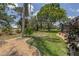 Expansive backyard with mature trees and manicured lawn at 1136 Highland Greens Dr, Venice, FL 34285