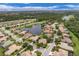 Community overview featuring a peaceful lake and various homes at 1311 Tuscany Blvd, Venice, FL 34292