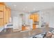 Kitchen with light wood cabinets, an island, and views into other rooms at 1311 Tuscany Blvd, Venice, FL 34292