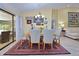Bright dining room featuring a table with seating for six and access to a relaxing patio at 217 Carriage House Ln # 217, Nokomis, FL 34275
