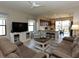 Spacious living room with comfortable seating, large TV, and adjacent kitchen at 232 Carlino Dr, Nokomis, FL 34275