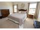 Spacious main bedroom with king bed, nightstands, and large windows at 232 Carlino Dr, Nokomis, FL 34275