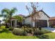 Single-story home with brown garage door and landscaped yard at 232 Carlino Dr, Nokomis, FL 34275