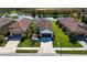 Single-story home with brown tile roof, two-car garage, and manicured lawn at 232 Carlino Dr, Nokomis, FL 34275